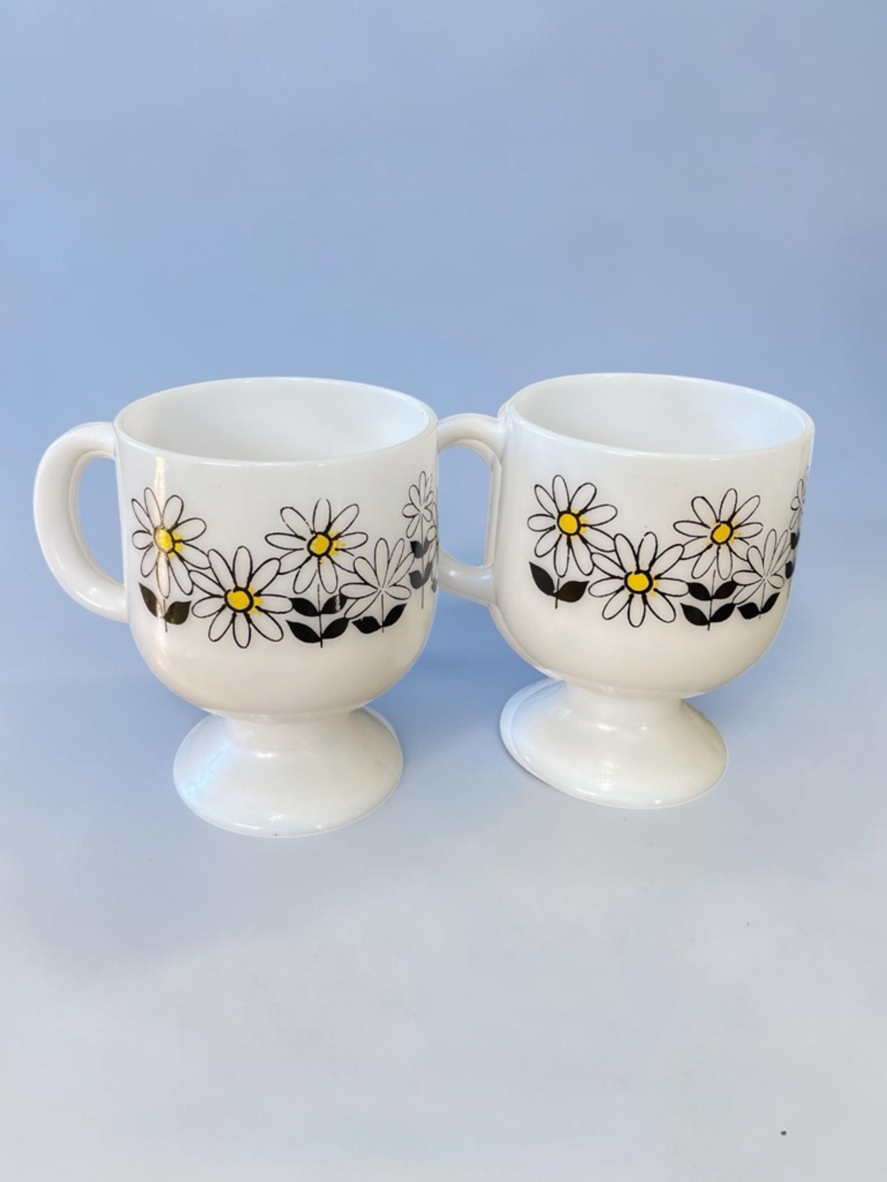Two pedestal vintage coffee mugs, daisy design, milk, glass